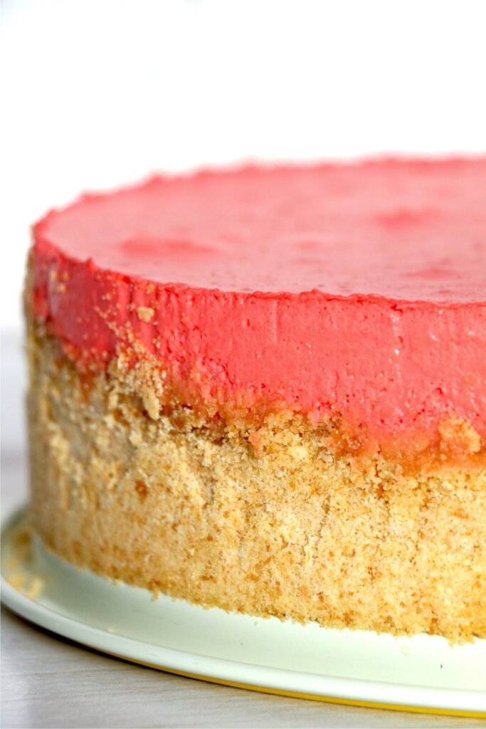 Closeup profile shot of no-bake strawberry jello cheesecake on plate