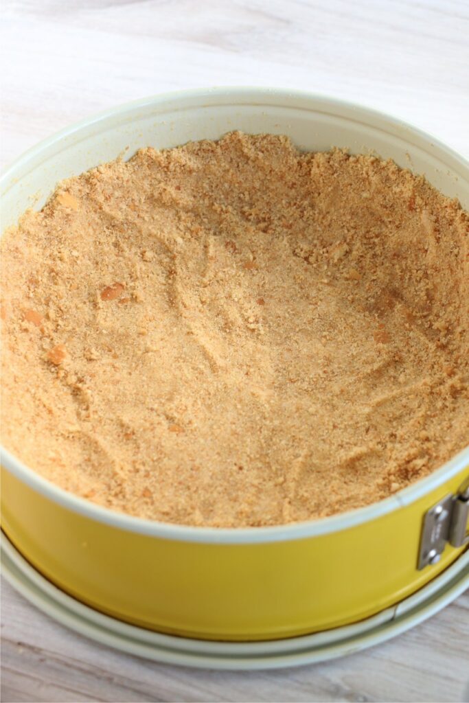 Nilla wafer crust pressed into the bottom of a springform pan
