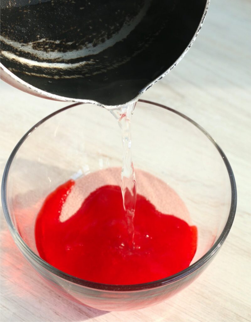 Water being poured into bowlful of Jello