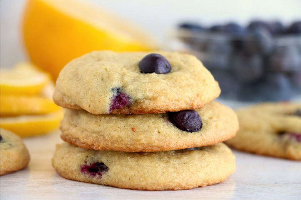 Closeup shot of three lemon blueberry cookies stacked atop one another.