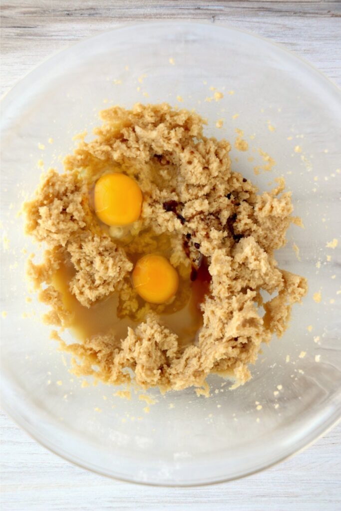 Overhead shot of eggs and creamed butter and sugar in mixing bowl