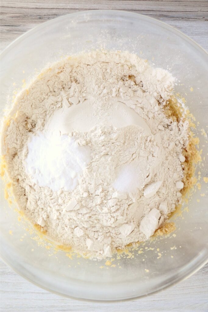 Overhead shot of dry ingredients added to wet ingredients in mixing bowl
