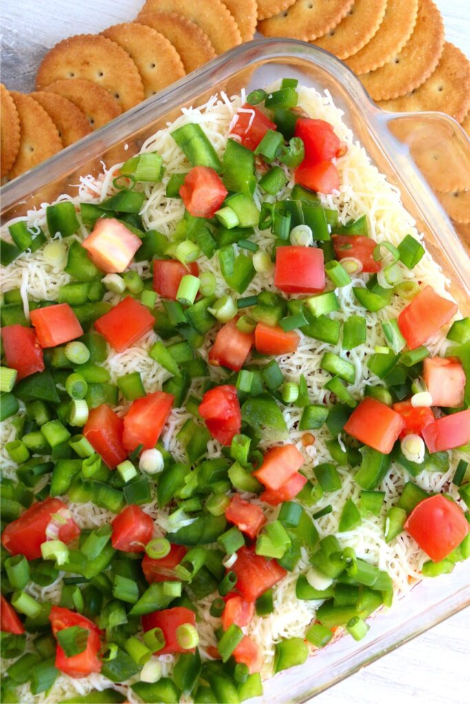 Overhead shot dish full of seafood cheese dip surrounded by crackers