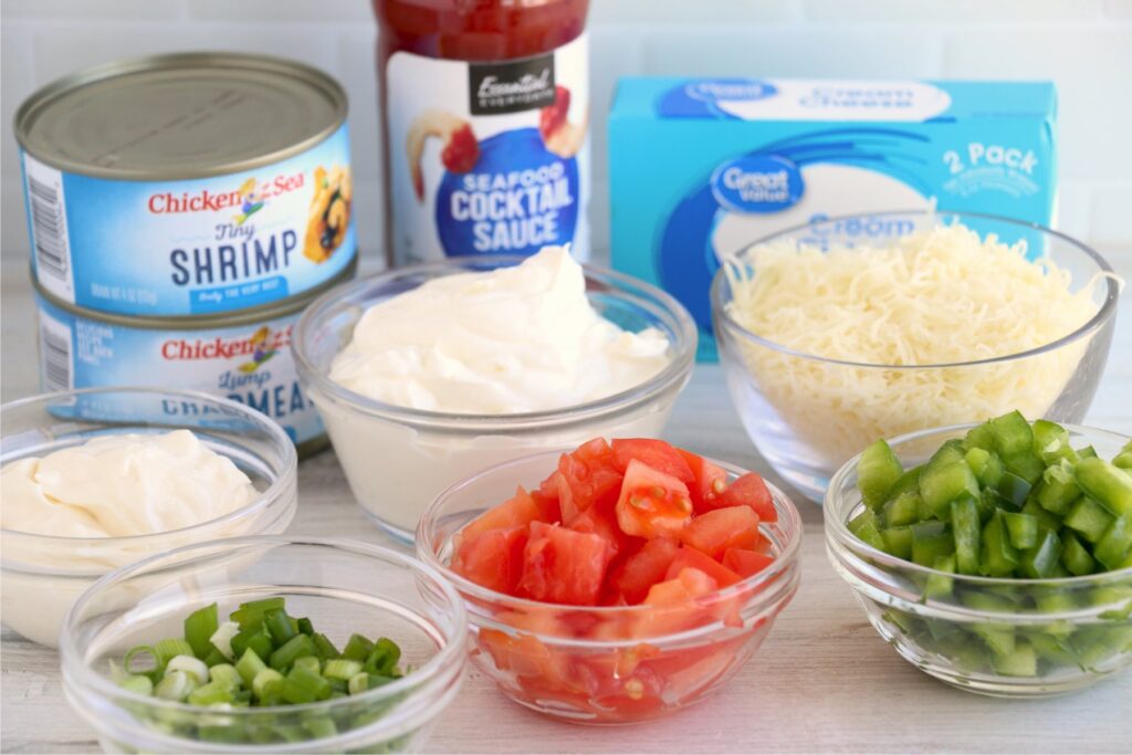 Seaffod cheese dip ingredients in individual containers on table