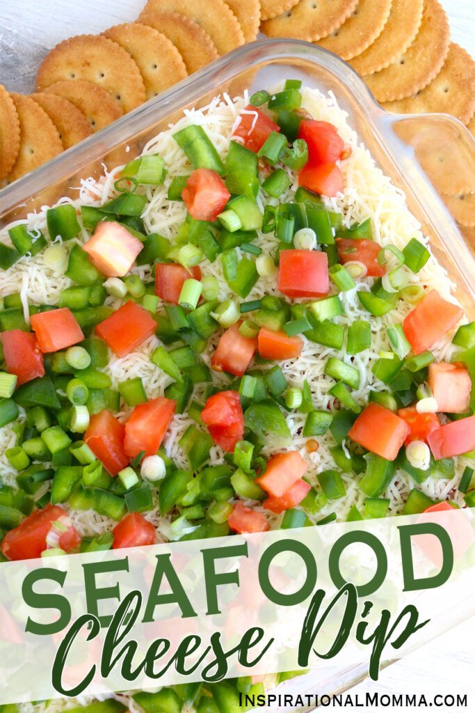 Overhead shot of seafood cheese dip in container next to crackers.