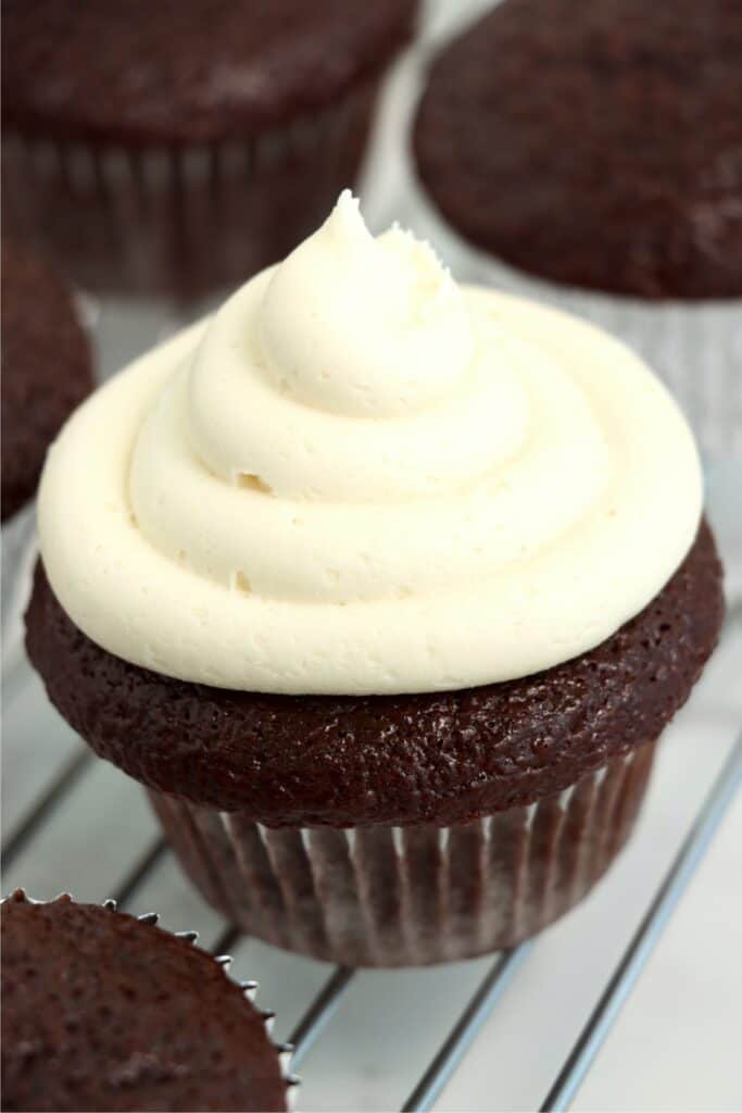 Closeup shot of chocolate cupcake topped with buttercream frosting.