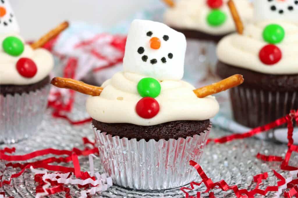 Closeup shot of chocolat snowman cupcakes on serving plate.