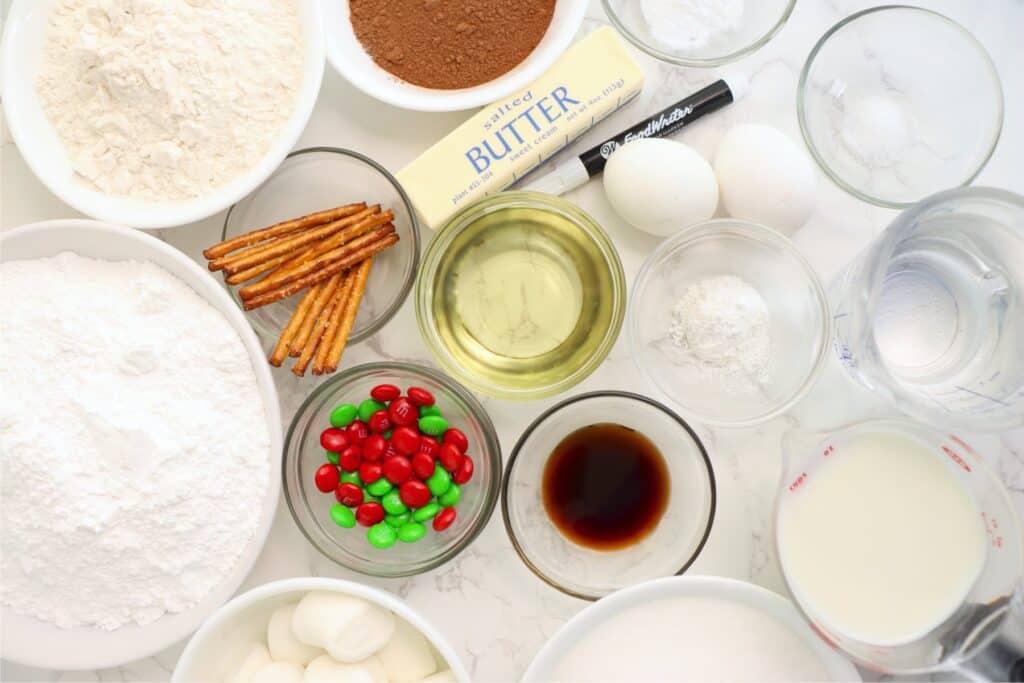 Overhead shot of chocolate snowman cupcake ingredients in individual bowls on table