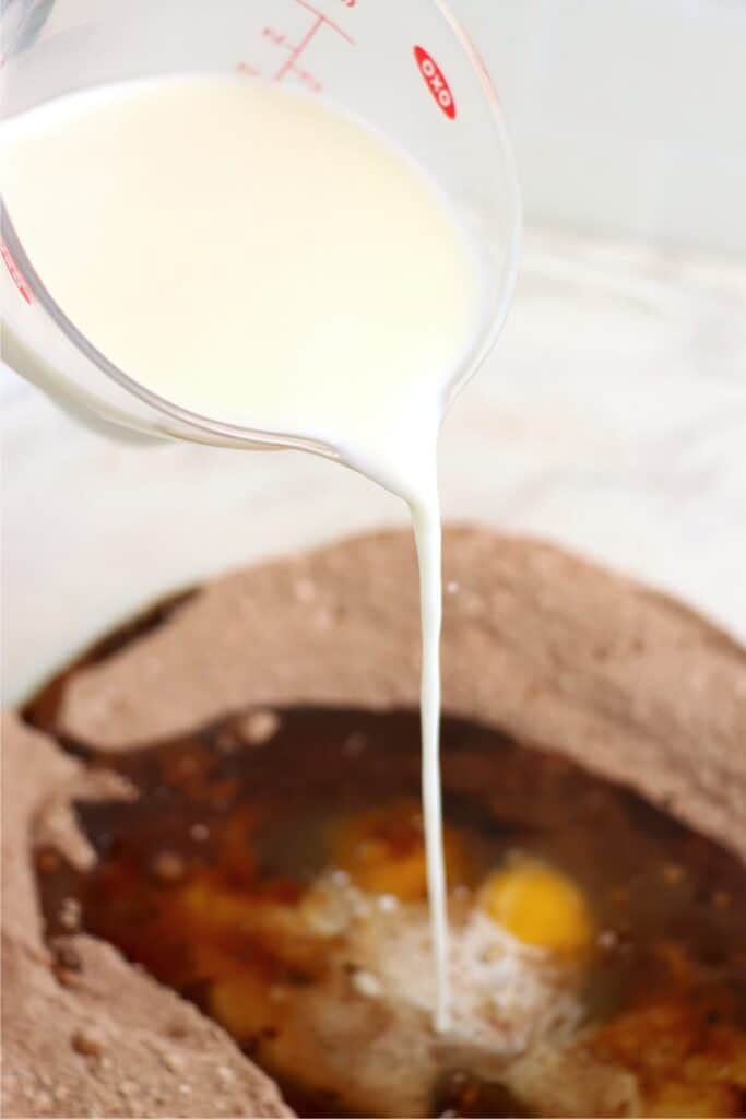 Milk being poured into bowl of other cupcake ingredients