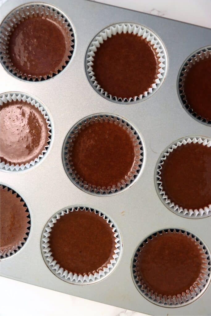 Overhead shot of cupcake tin filled with chocolate batter