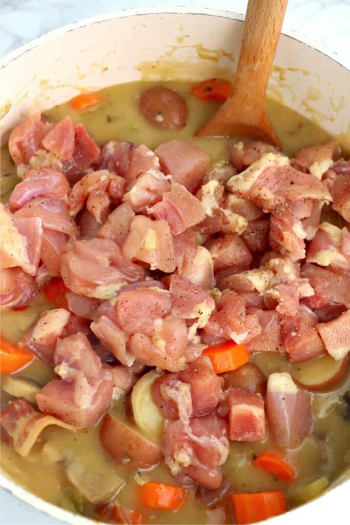 Chicken thigh meat in pot of soup