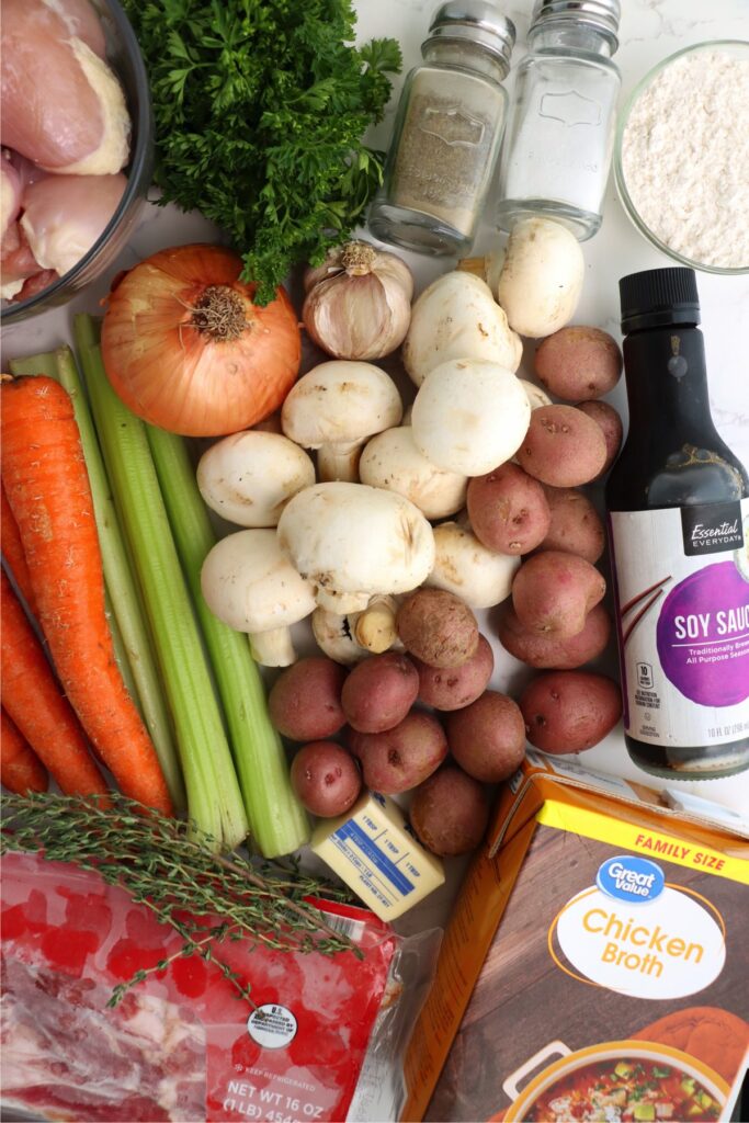 Overhead shot of individual chicken thigh stew ingredients on table