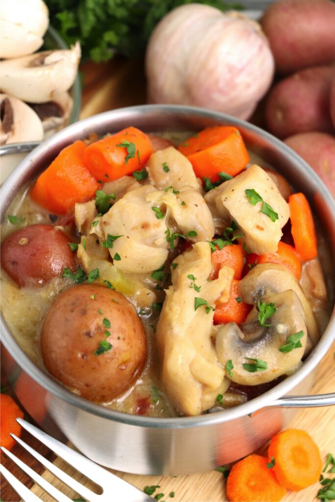 Chicken thigh stew in pot on table