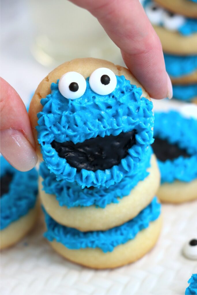 Closeup shot of hand holding Cookie Monster cookie