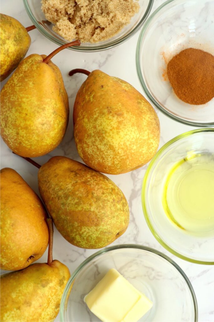 Overhead shot of ingredients for grilled pears in individiual bowls on table