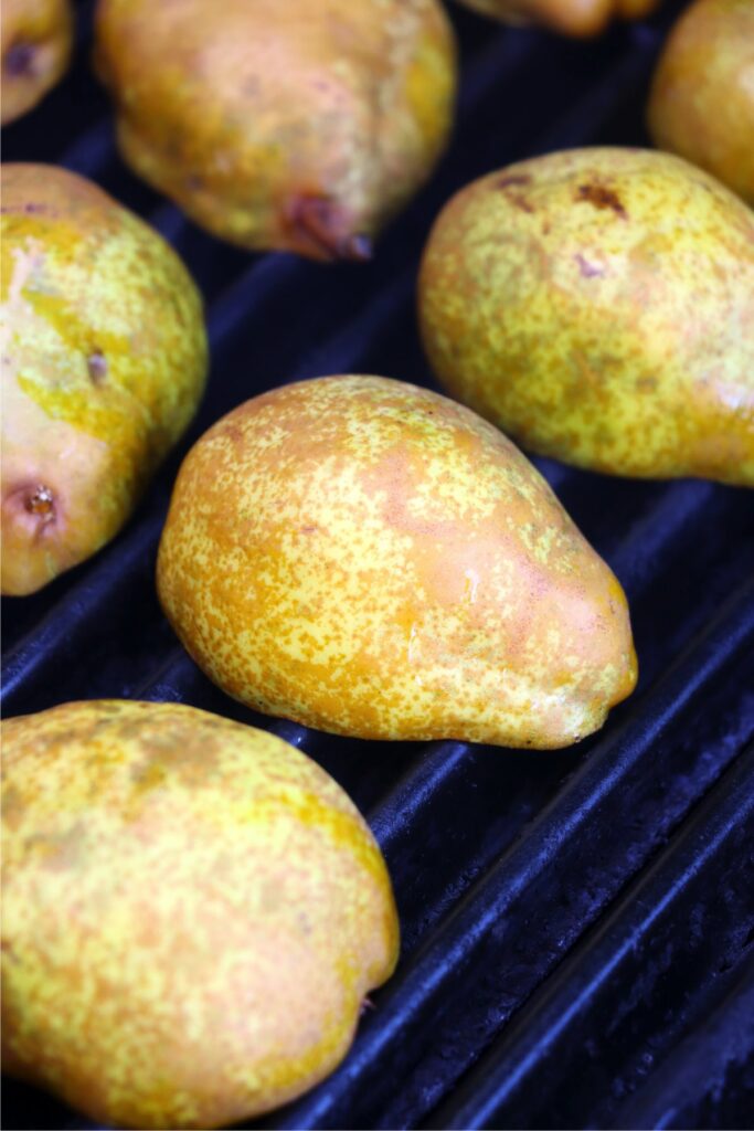  Closeup shot of cut pears, cut side down on grill grate