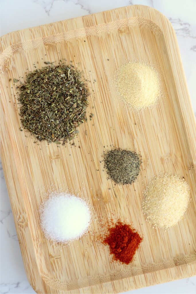 Overhead shot of individual meatloaf seasoning ingredients on cutting board