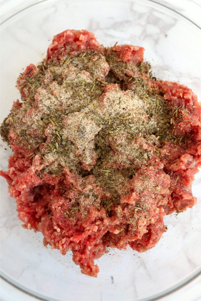Overehead shot of ground beef and meatloaf seasoning in bowl
