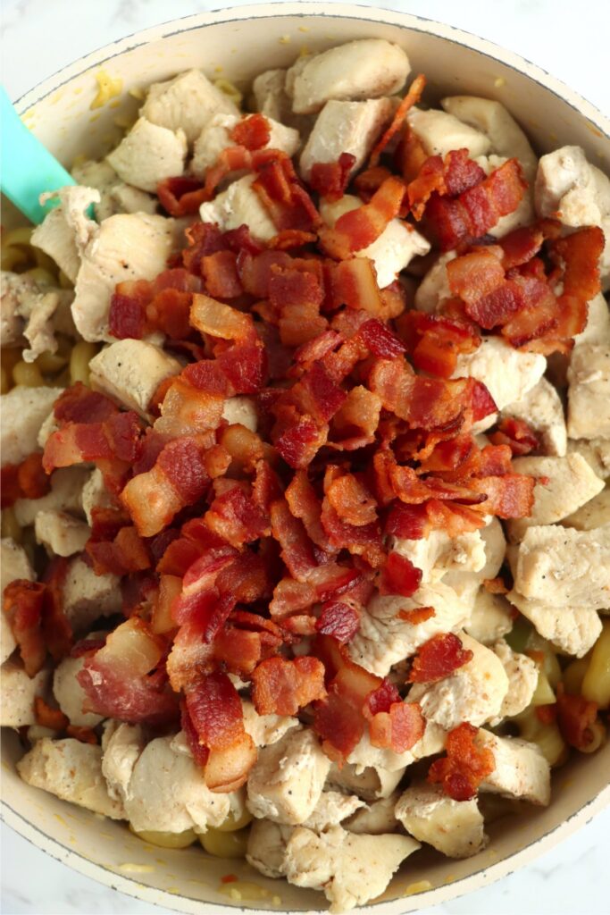 Closeup overhead shot of chicken and bacon in skillet