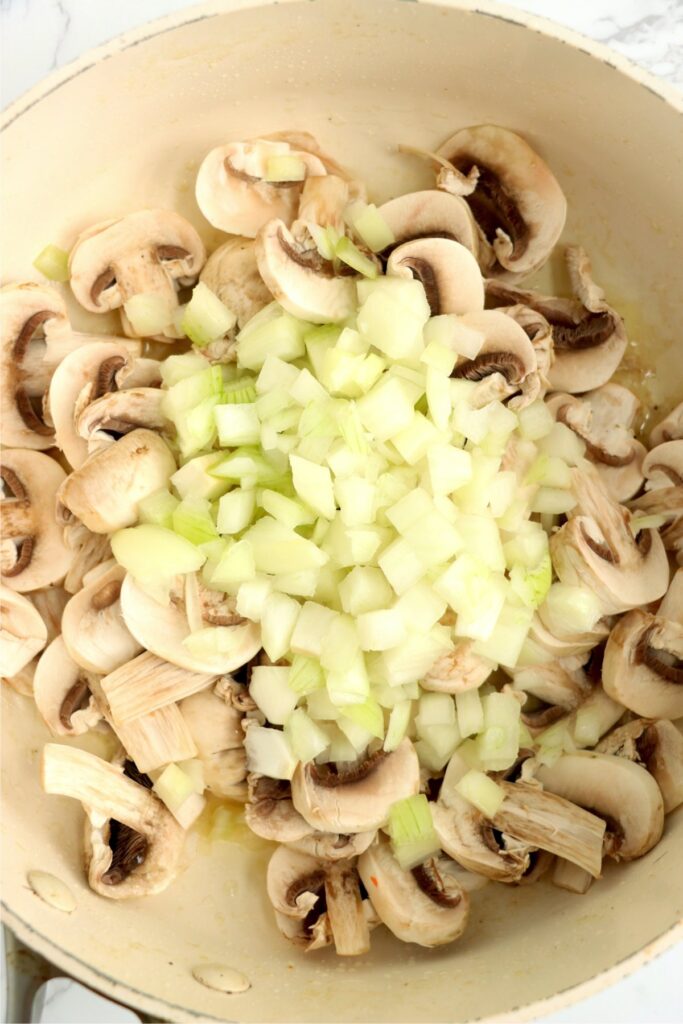 Overhead shot of mushroom and onions in skillet