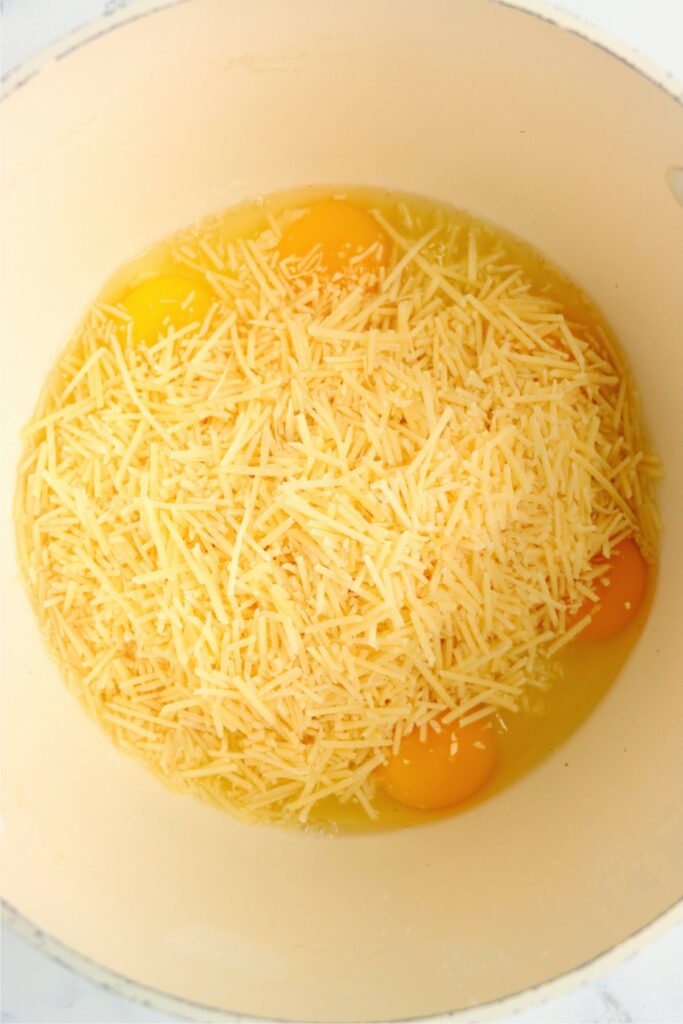 Overhead shot of eggs and cheese in pot