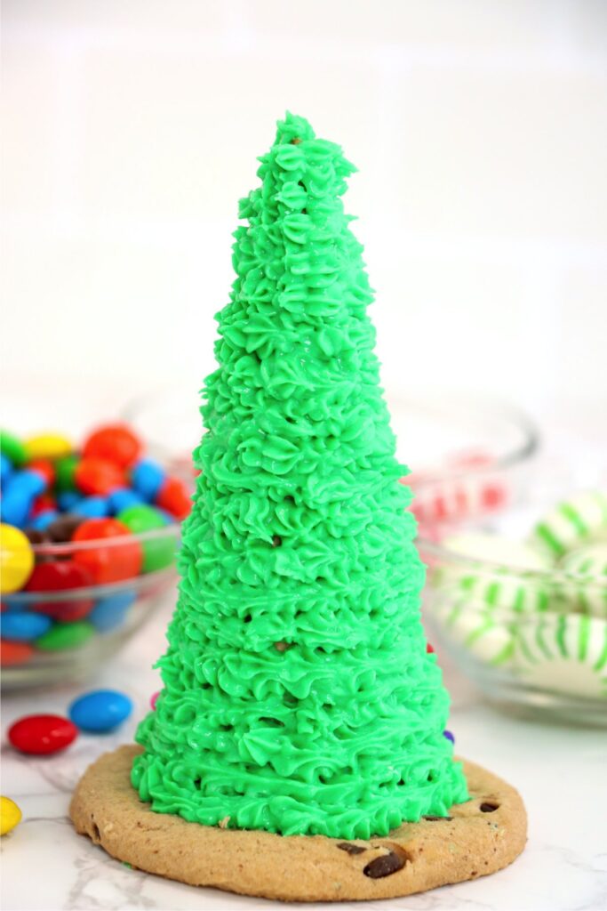 Closeup shot of frosted sugar cone sitting on top of cookie
