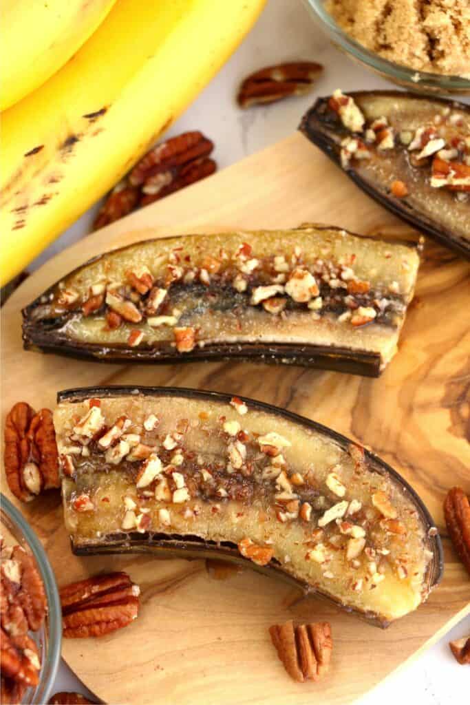 Closeup overhead shot of air fryer bananas on cutting board