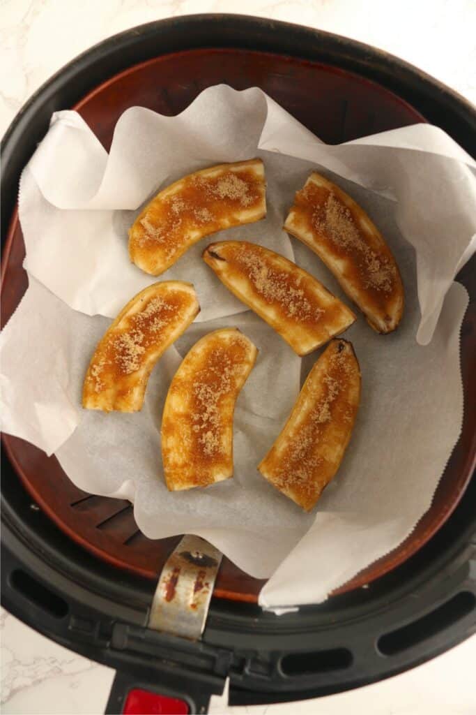 Overhead shot of brown sugar topped bananas in air fryer basket