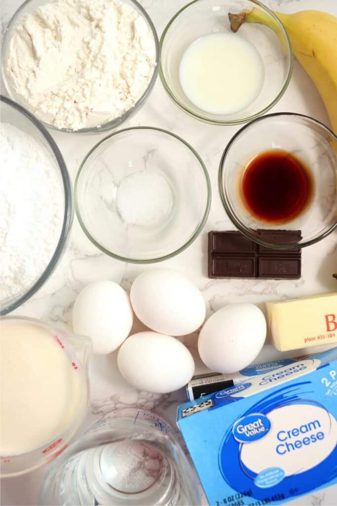 Overhead shot of individual banana cream puff ingredients in bowls on table