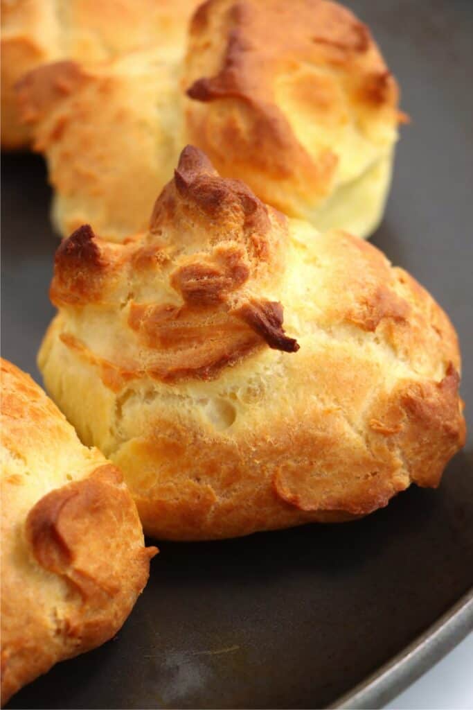 Closeup shot of baked creampuffs on baking sheet