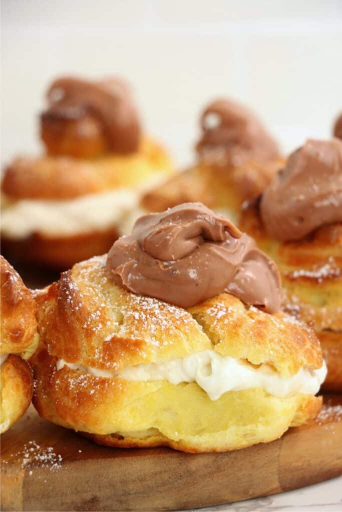 Closeup shot of banana cream puffs on kitchen board