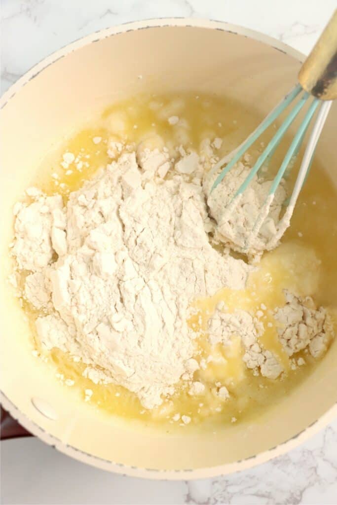 Closeup overhead shot of flour mixture being mixed in saucepan