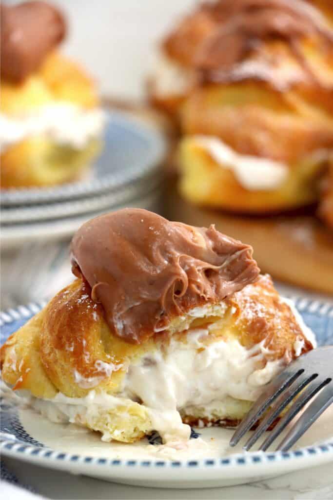 Closeup shot of banana cream puff cut in half on plate