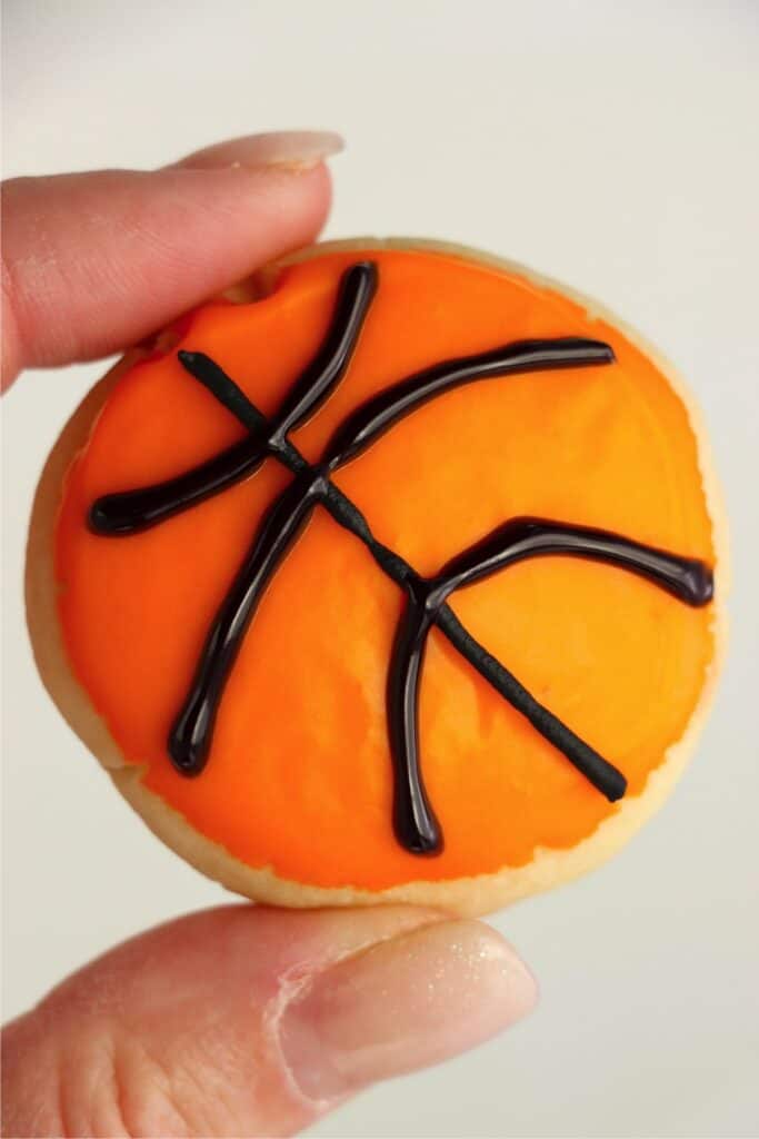 Closeup shot of hand holding basketball sugar cookie