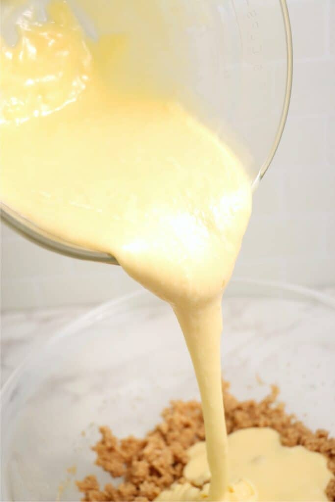 Sweetened condensed milk mixture being poured into mixing bowl