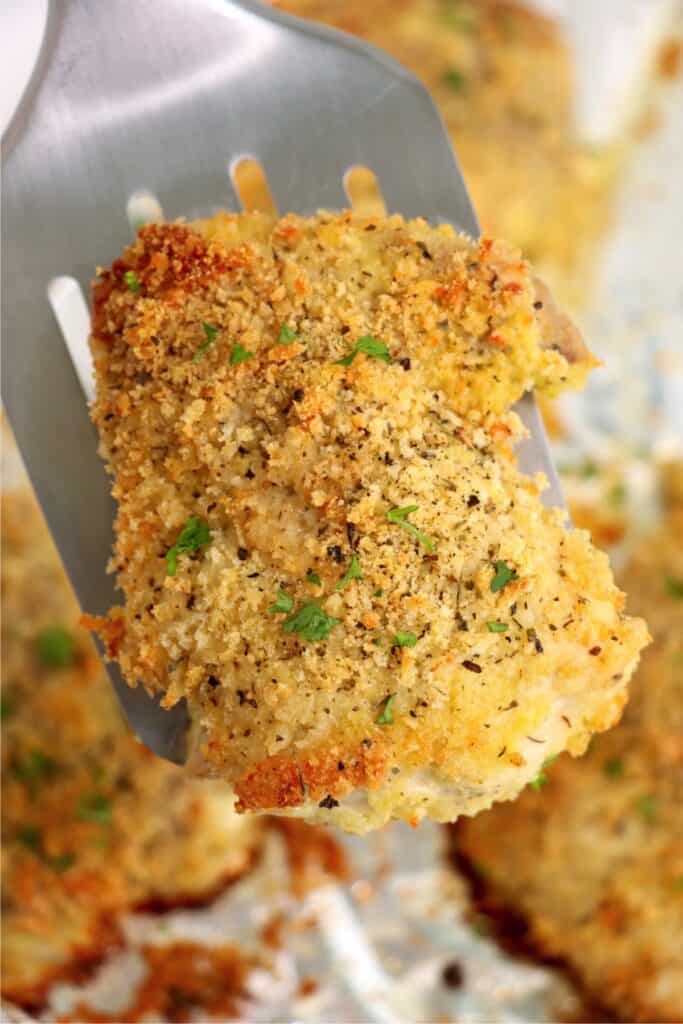 Closeup shot of garlic parmesan chicken thigh on spatula