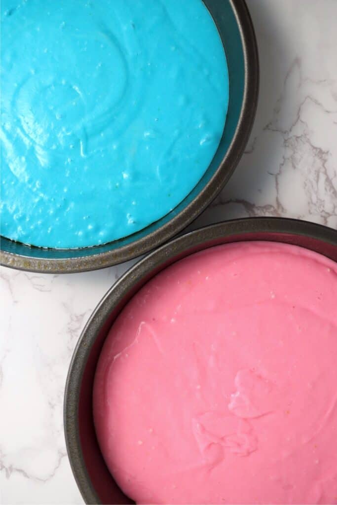 Overhead shot of cake pans with blue and pink batter