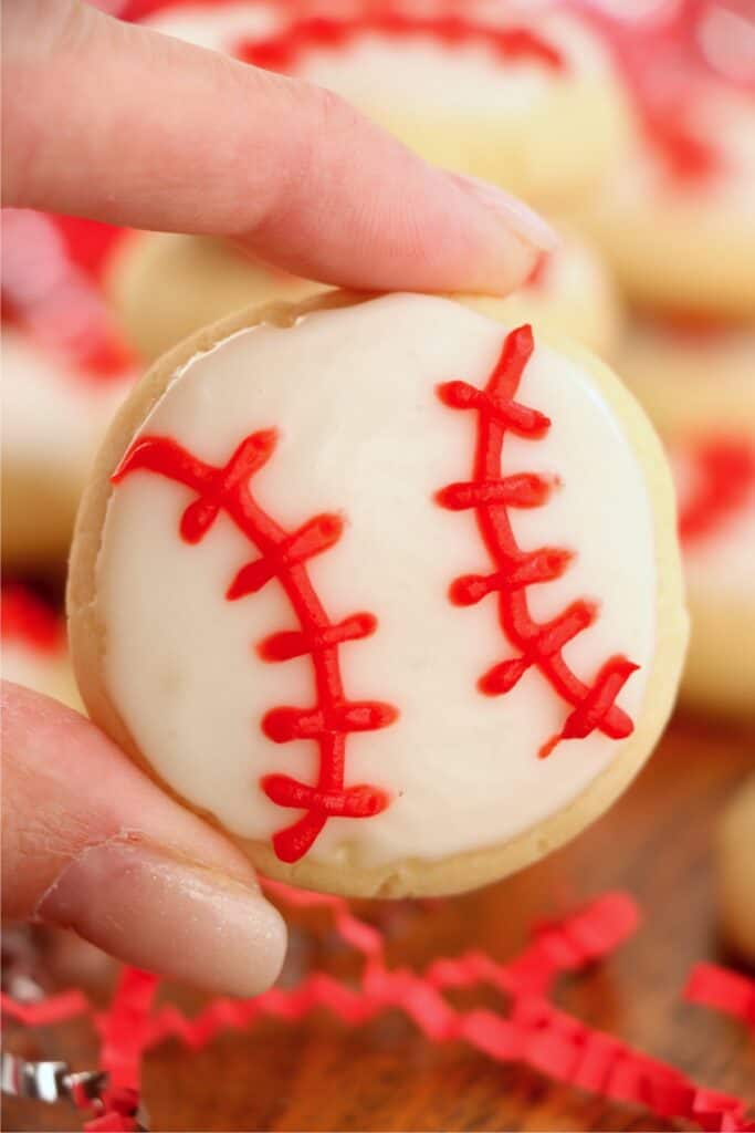 Closeup shot of hand holding baseball sugar cookie