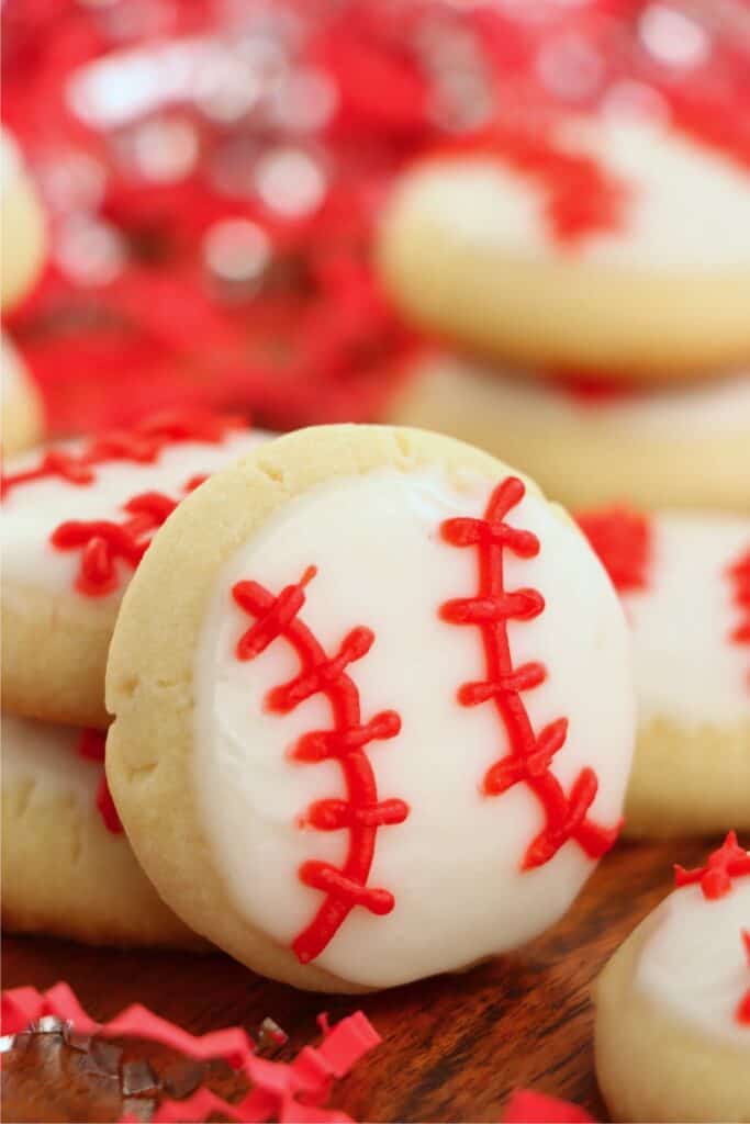 Closeup shot of baseball sugar cookie with more sugar cookes in background