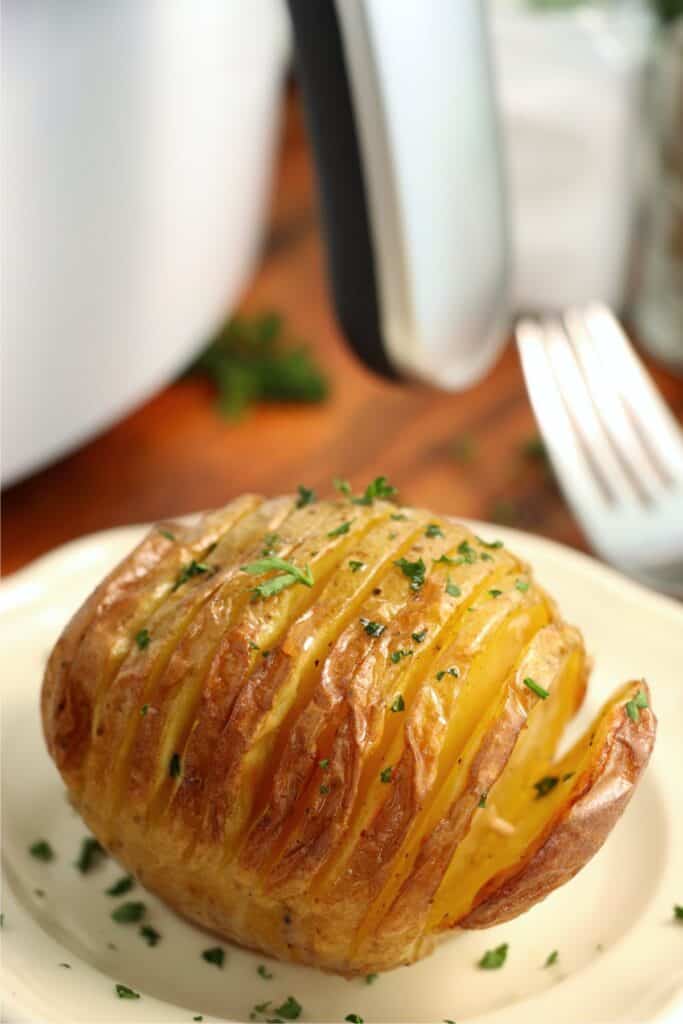 Closeup shot of Hasselback potato on plate