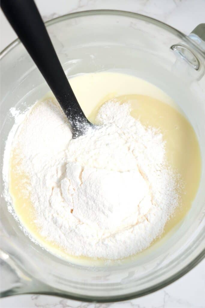 Overhead shot of mixing bowl full of melted chocolate, sweetened condensed milk, and banana pudding mix