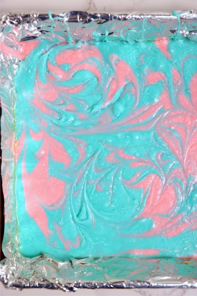 Overhead shot of blue and pink fudge swirled together.