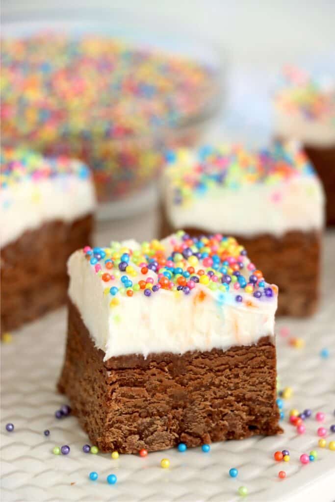 Closeup shot of frosted fudge square with more fudge squares in background