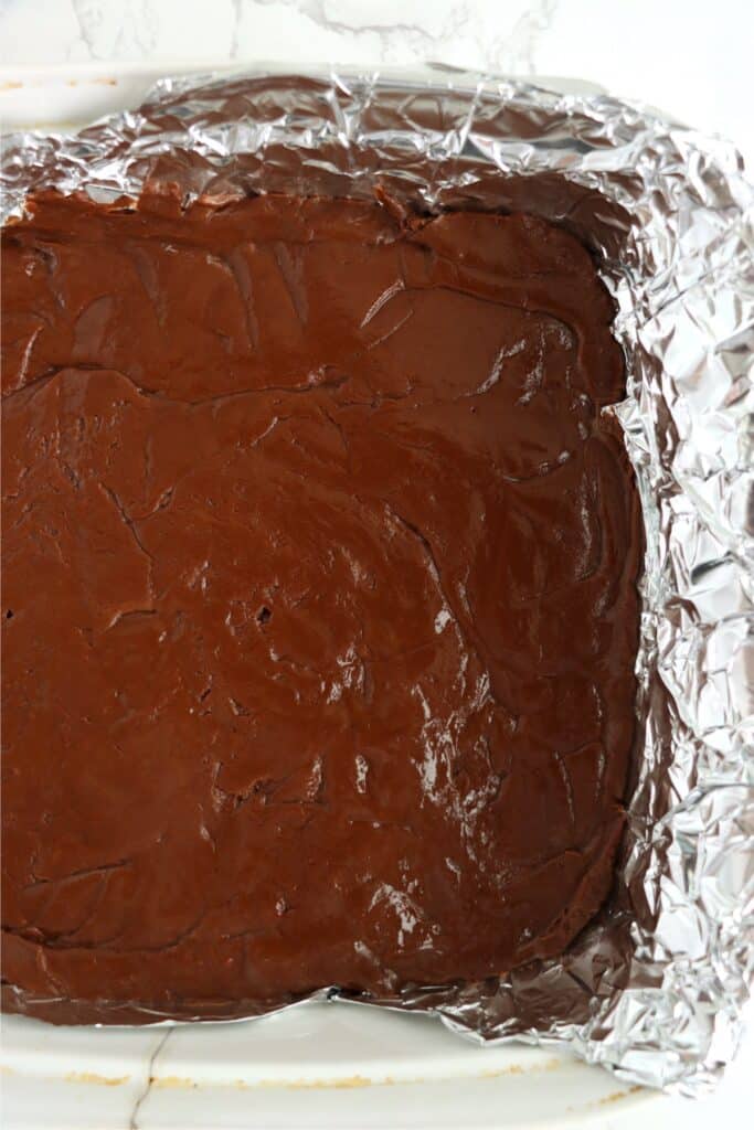 Overhead shot of chocolate fudge in bakind dish lined with foil