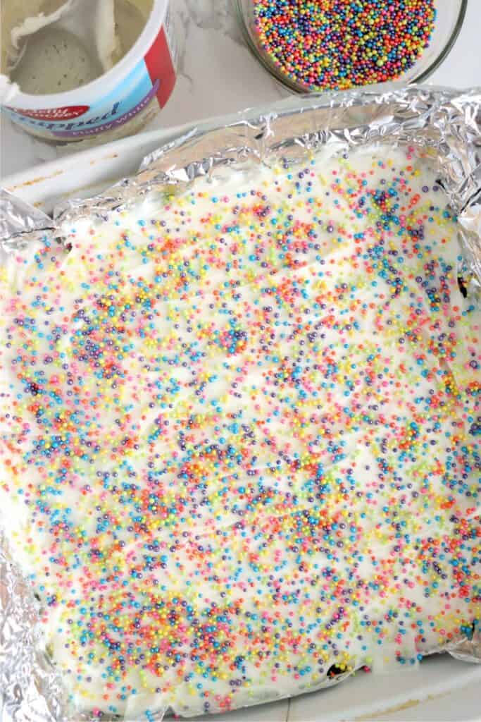 Overhead shot of frosted fudge topped with sprinkles