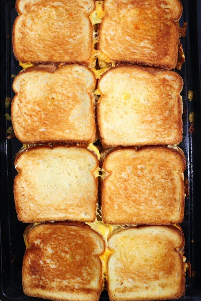 Overhead shot of oven baked grilled cheese sandwiches on baking sheet