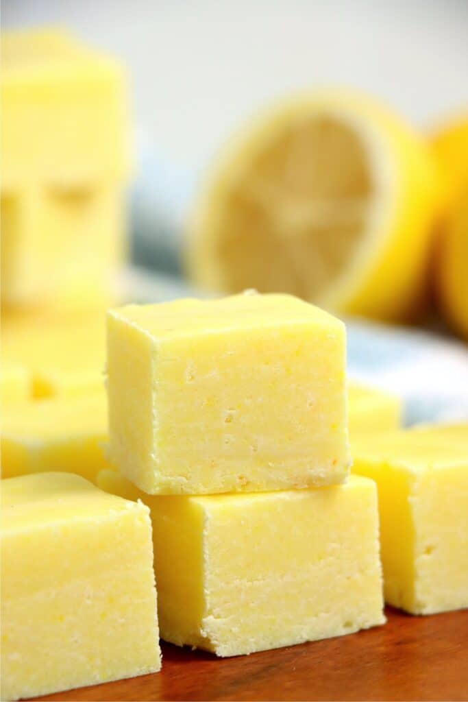 Closeup shot of lemon fudge squares stacked atop one another.