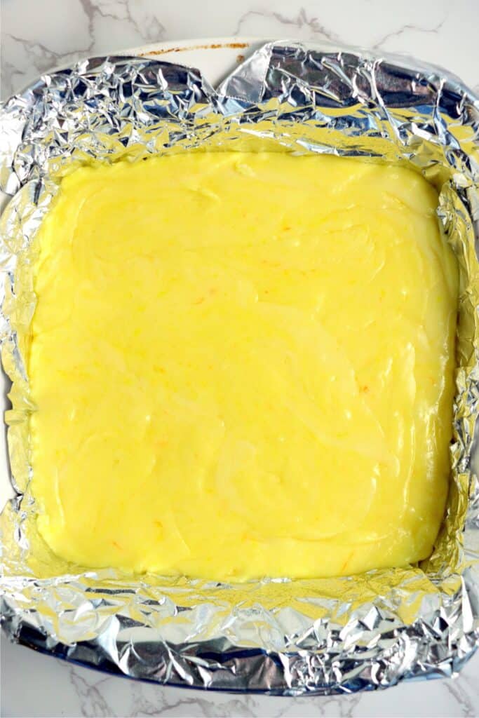 Overhead shot of lemon fudge in bakind dish lined with foil