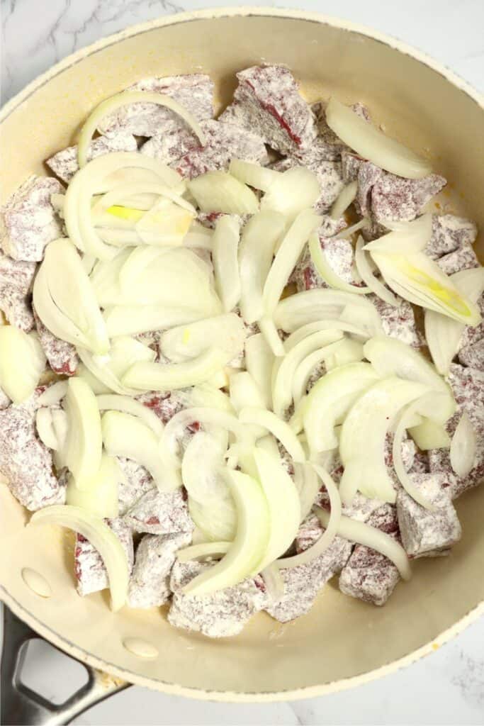 Overhead shot of venison heart and onions in skillet