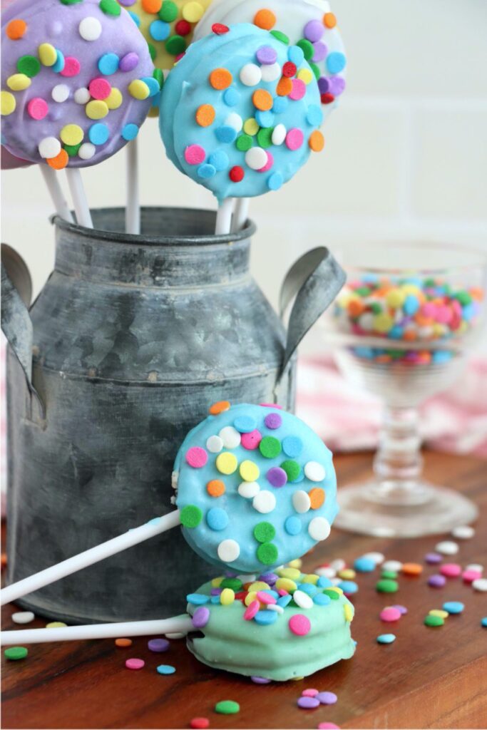 Easter chocolate covered Oreos in metal bucket with more chocolate covered Oreos in front of it